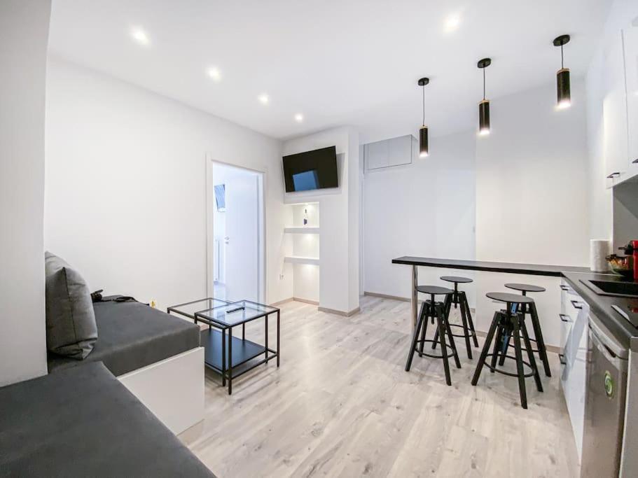 a kitchen and living room with a table and chairs at Syntagma square, 60sqm Platinum suite in Athens