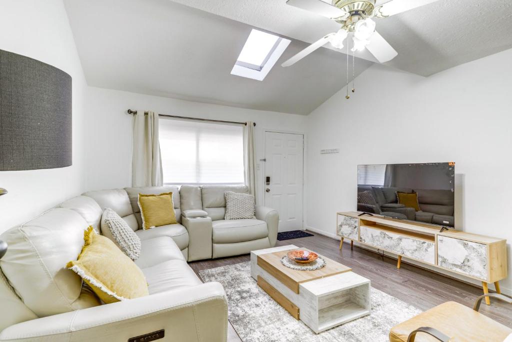 a living room with a white couch and a table at Quiet Houston Townhome Near Parks and Shopping in Houston