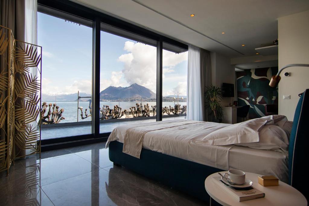 a bedroom with a large window with a view of the water at Gigi Suites&Apartments in Stresa