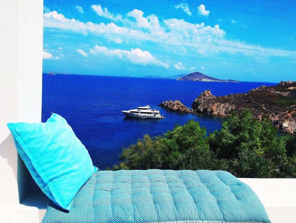 a boat in the ocean with a boat in the water at Patmos Garden Sea in Grikos