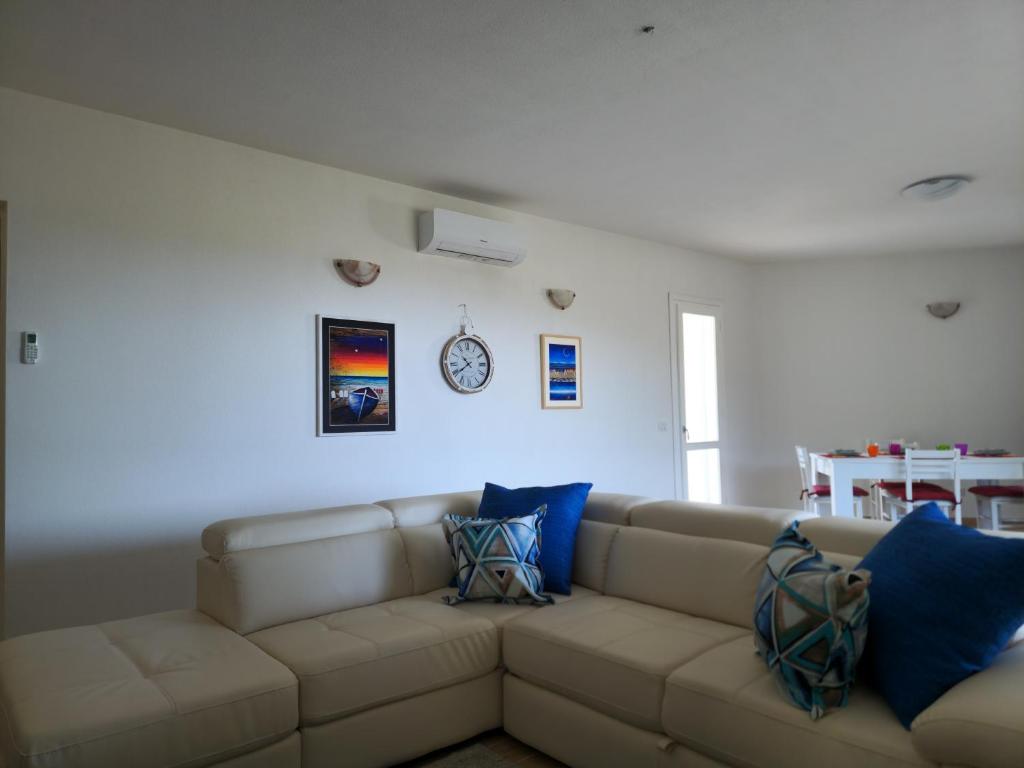 - un salon avec un canapé marron et des oreillers bleus dans l'établissement Villa Lu Tizzoni, à Budoni