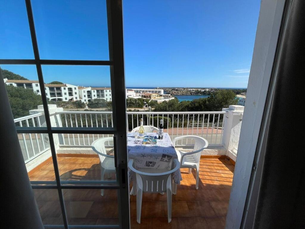 a balcony with a table and chairs on a deck at Apartamento 204 Castell Sol CB in Arenal d'en Castell