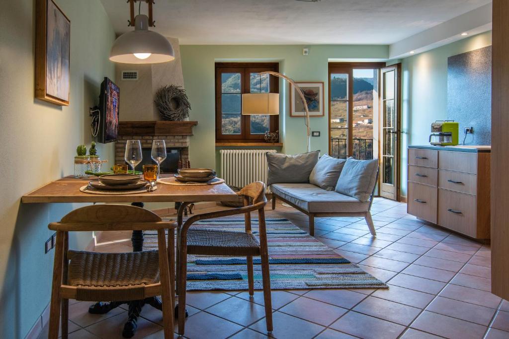 cocina y sala de estar con mesa y sillas en Casa San Francesco Apt 1, en Tremosine Sul Garda