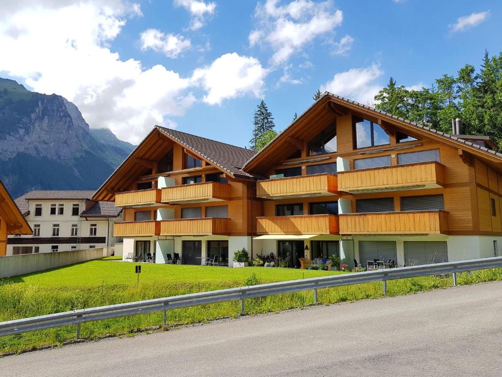 a large wooden building with a mountain in the background at Apartment Ibex by Interhome in Kandersteg