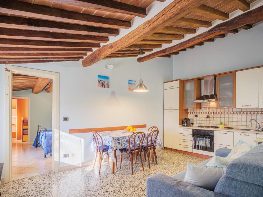 Il comprend une cuisine et un salon avec une table et des chaises. dans l'établissement Apartment Casina stella al mare by Interhome, à Querceta