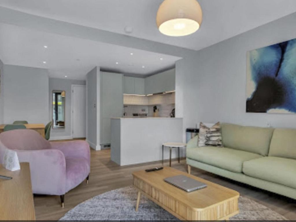 a living room with a couch and a table at Apartment Wembley Park apartments-2 by Interhome in London