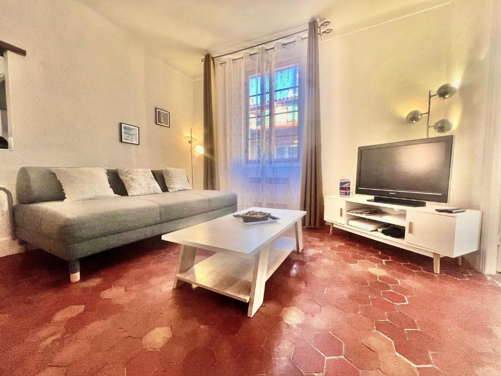 a living room with a couch and a tv at AA OT Maison du Moulin - Old Town - Promenade des in Nice