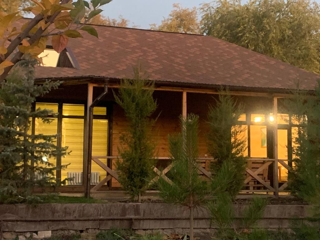 a log cabin with a wrap around porch at Отель Рублёвка in Kant