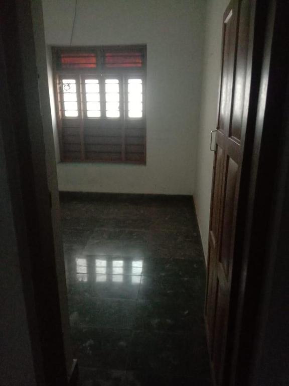 an empty room with a door and a window at Kailas in Kollam