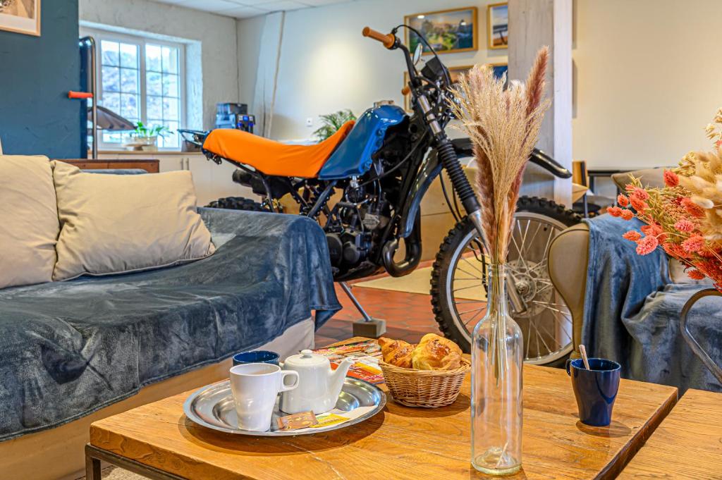 a motorcycle parked in a living room with a coffee table at Naéco Erdeven in Erdeven