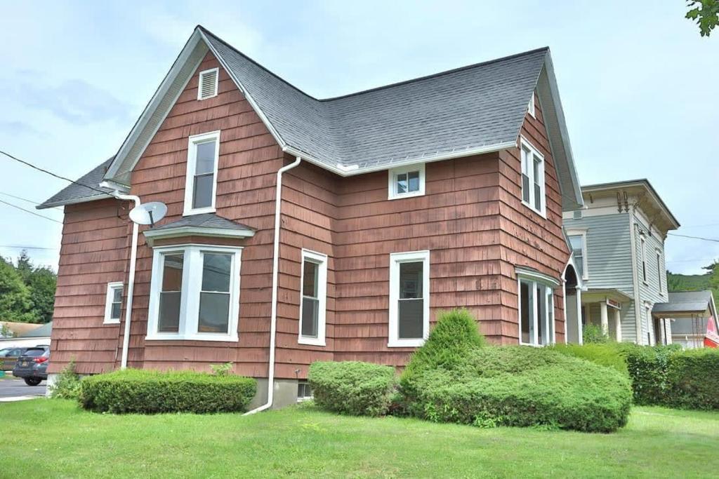 a brown house with a gray roof at Center Field All Star Baseball Rentals in Oneonta