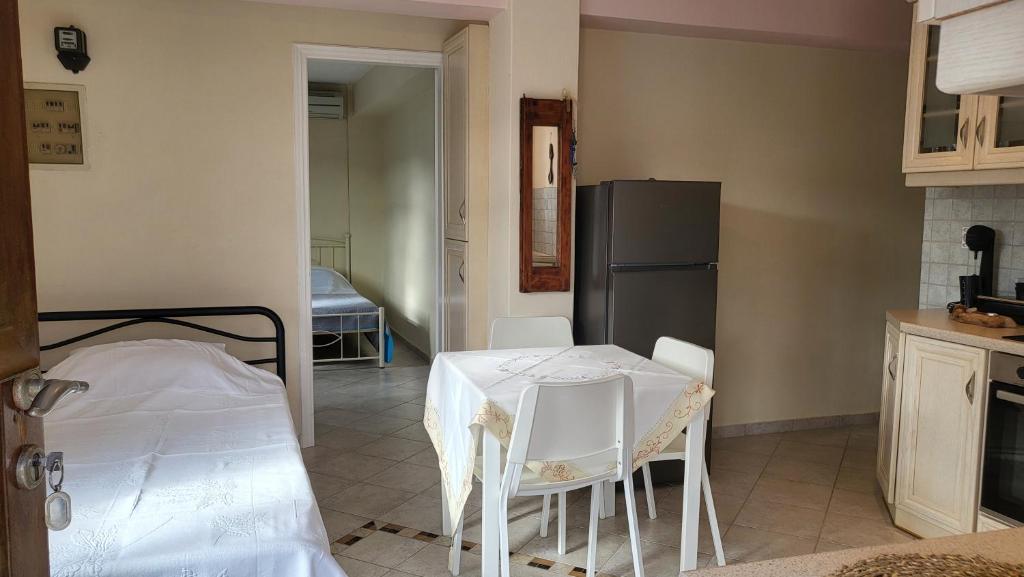 a kitchen with a table and a refrigerator at Eirini Home in Andros