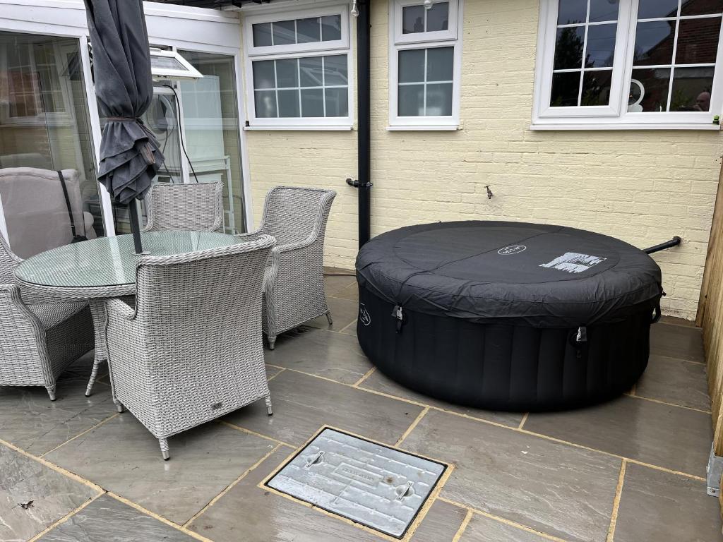 a large black tire sitting next to a table and chairs at Immaculate 4-Bed Cottage in Knaresborough in Knaresborough