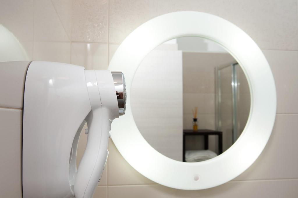 a white mirror on a wall in a bathroom at B&B Raffaello a Mare in Montesilvano
