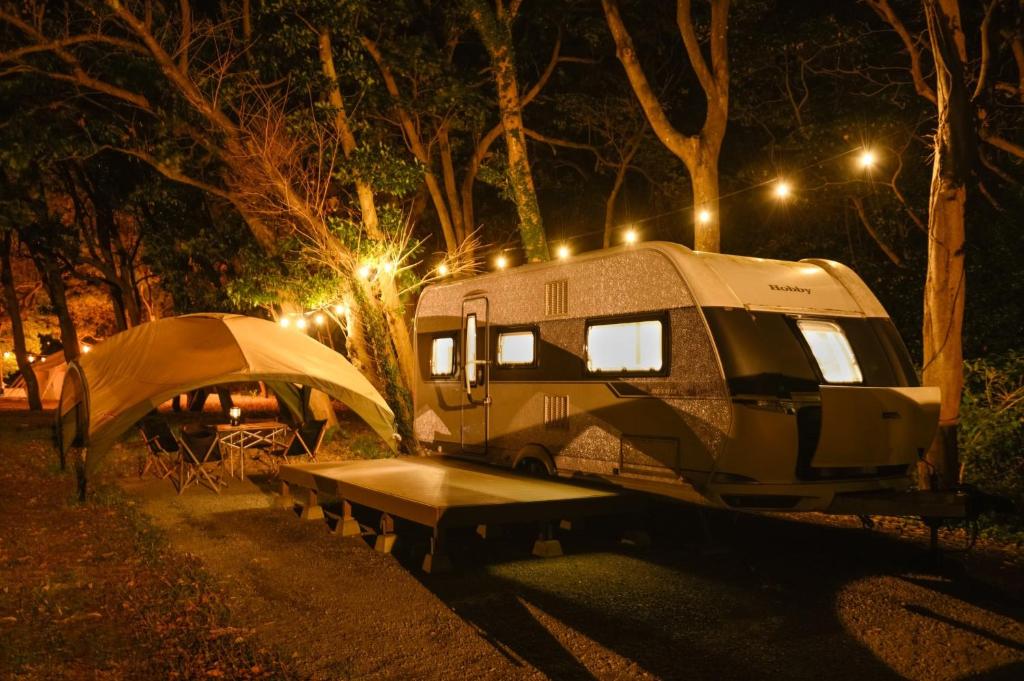a tent and a camper parked in a park at night at Nagasaki Hana Beach Resort - Vacation STAY 26611v in Kakaji