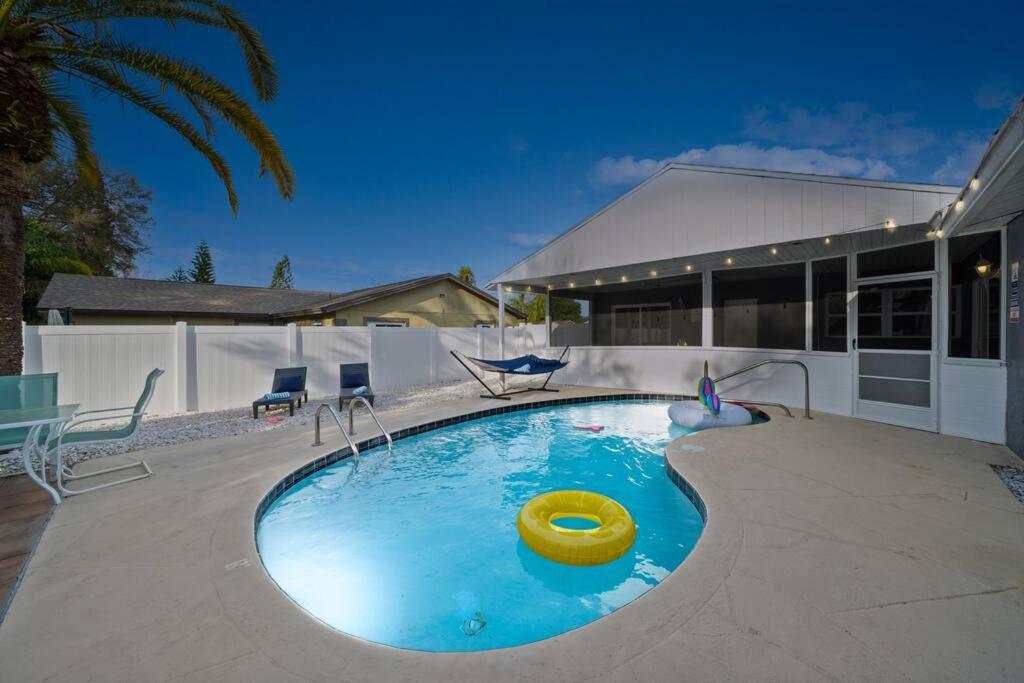 a swimming pool with a frisbee in the middle at Lux Sunny Family Paradise with Heated Pool and King Bed in Largo