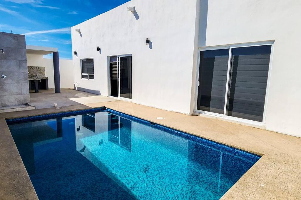 a swimming pool in front of a house at Villa Costa Felix 5 in Puerto Peñasco