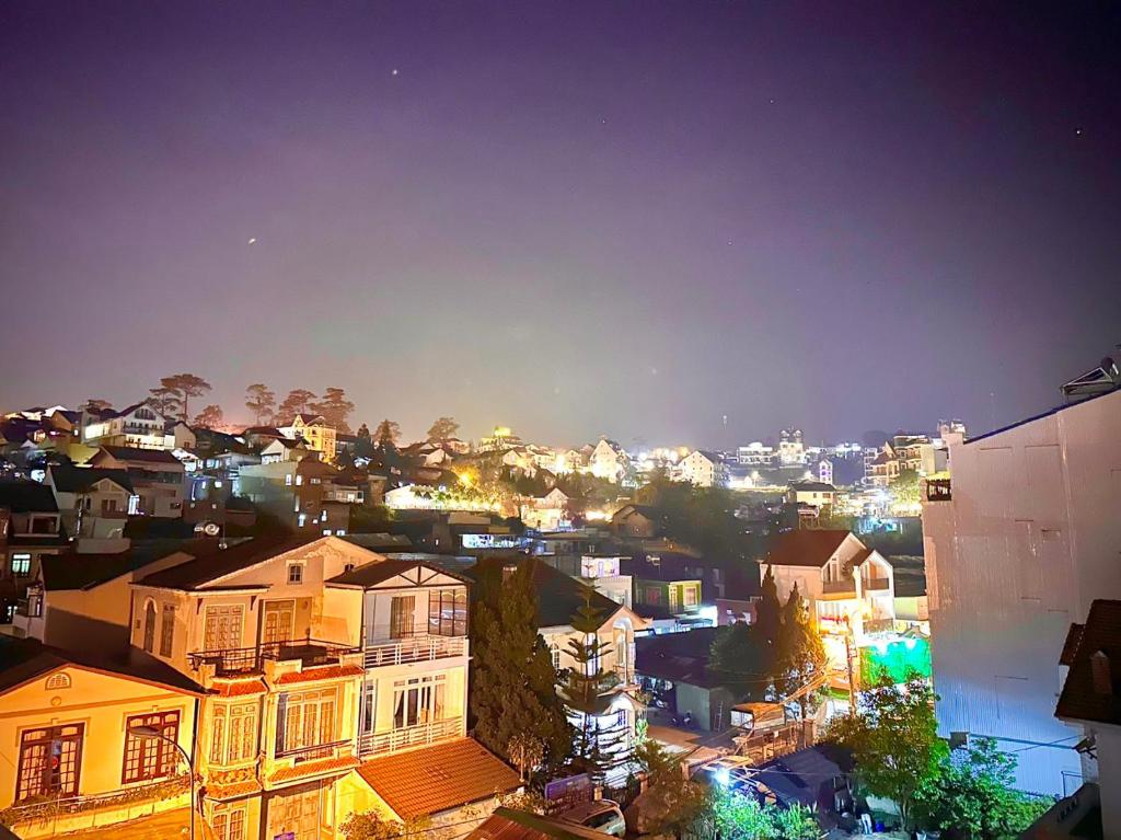 a view of a city at night at Mon's House in Da Lat