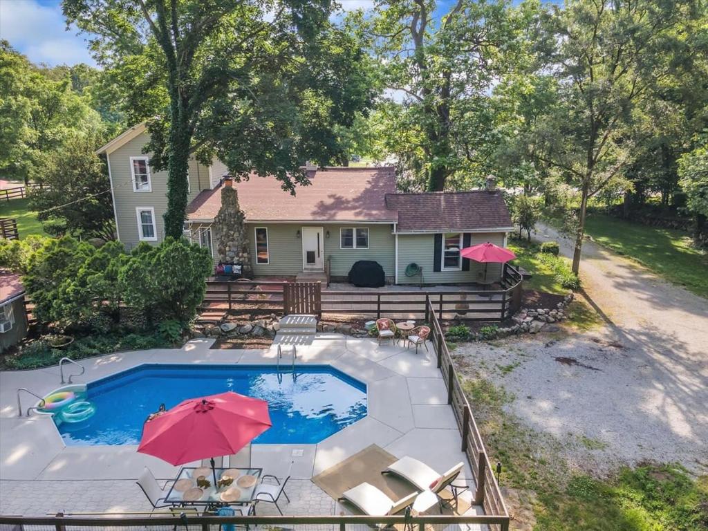 una vista aérea de una casa con una piscina con sombrillas en Deck & Modern Amenities! Hollyhock Hideaway, en South Bend