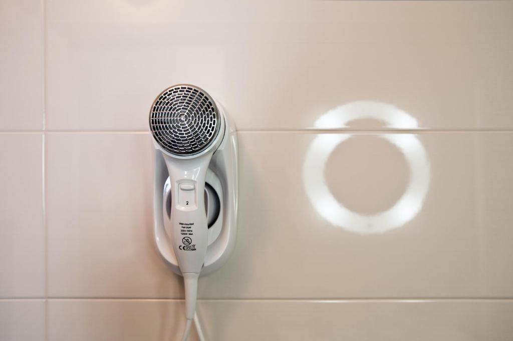 a blow dryer in the wall of a bathroom at B&B Raffaello a Mare in Montesilvano