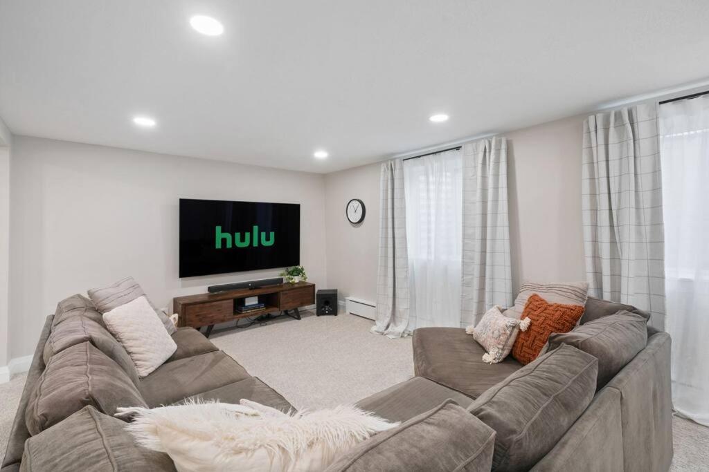 a living room with a couch and a flat screen tv at Spanish Fork Retreat in Spanish Fork