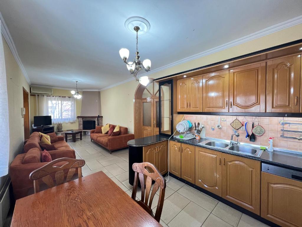 a kitchen and living room with a couch and a table at Tirana Center 2Bedrooms in Tirana