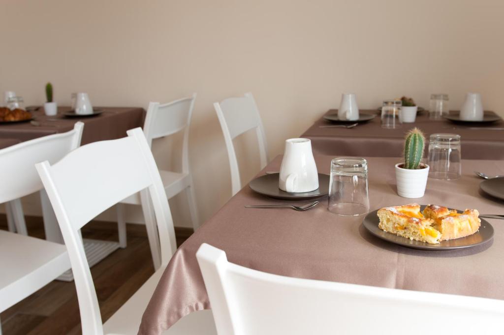 a table with a plate of food on it at B&B Raffaello a Mare in Montesilvano