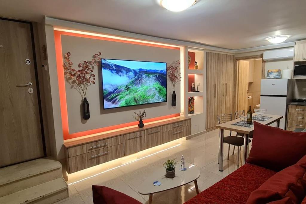 a living room with a flat screen tv on a wall at M&S Apartments Athens in Athens