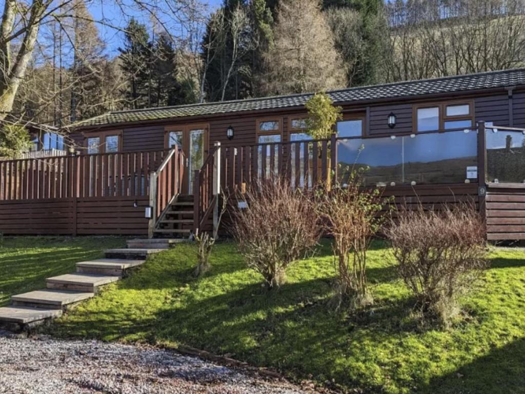 a cabin in the woods with a yard at Chalet Windermere Lodge by Interhome in Windermere