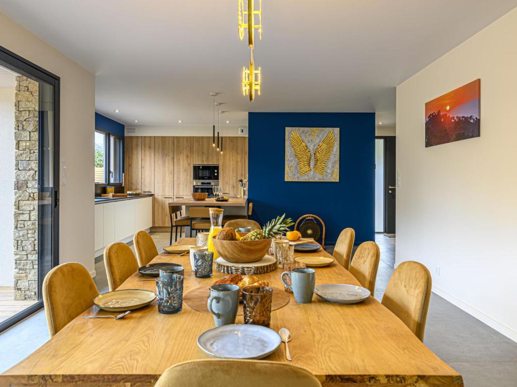 a dining room with wooden tables and chairs at Holiday Home Villa du Golf by Interhome in Baden