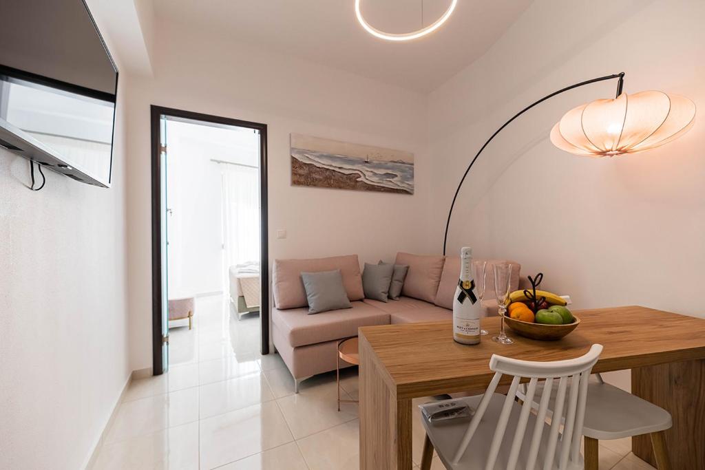 a living room with a table and a couch at Archangelos SKY Junior Apartment in Archangelos