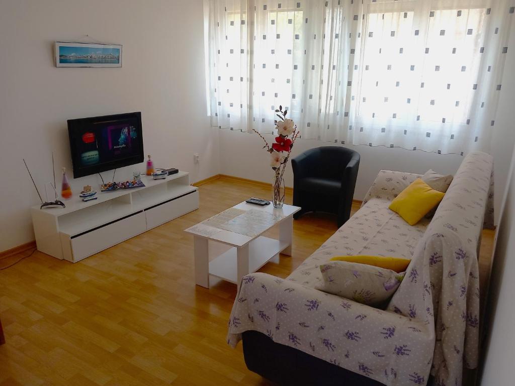 a living room with a couch and a tv at Apartment Mystic in Split
