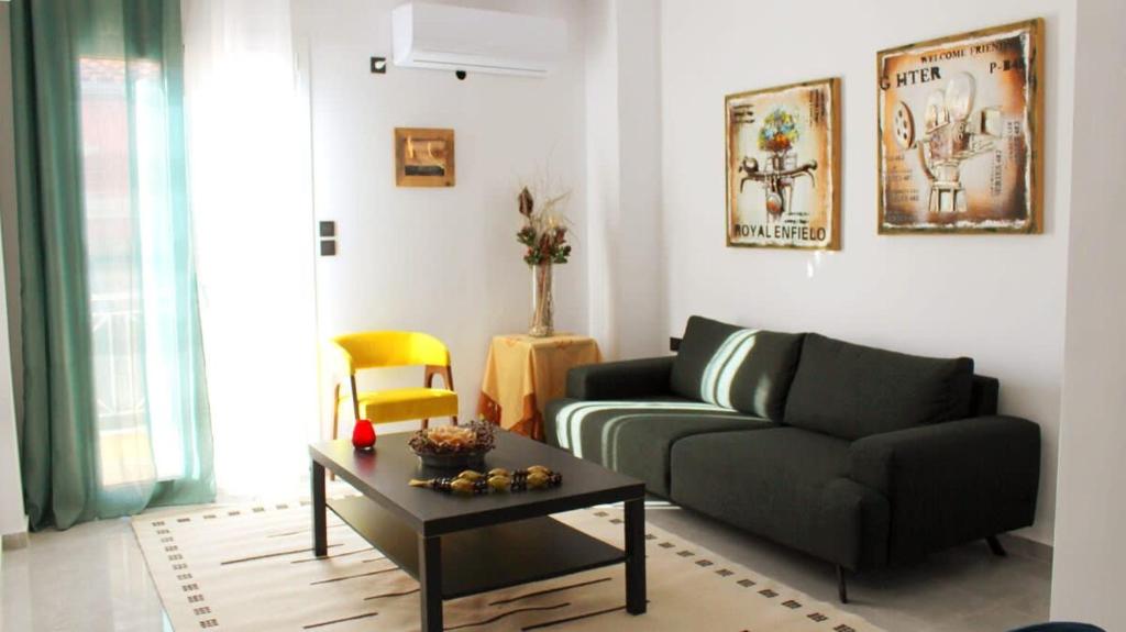 a living room with a couch and a coffee table at Patras Cozy Nest in the Vibrant City Center in Patra