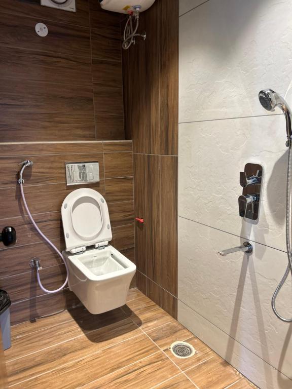 a bathroom with a toilet and a shower at Andaz Luxe Apartment. in Indore