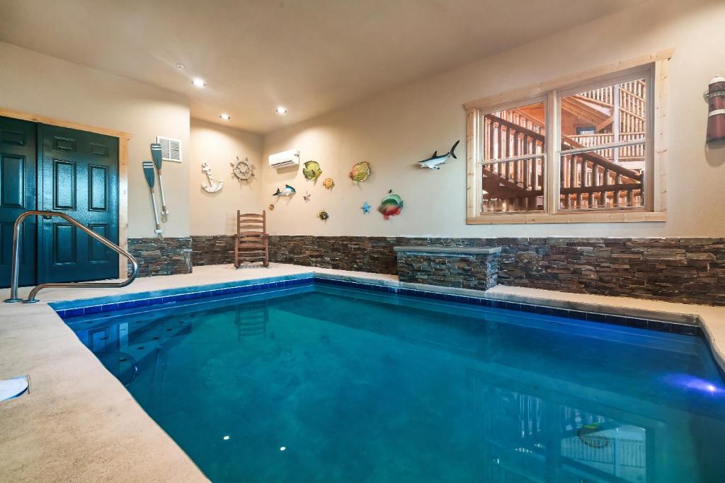 a swimming pool in a house at Cabin 6BR/8BA Smokies Views in Gatlinburg