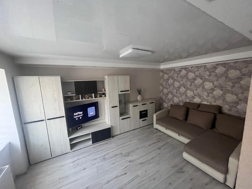 a small living room with a couch and a kitchen at ZE Apartments in Rēzekne