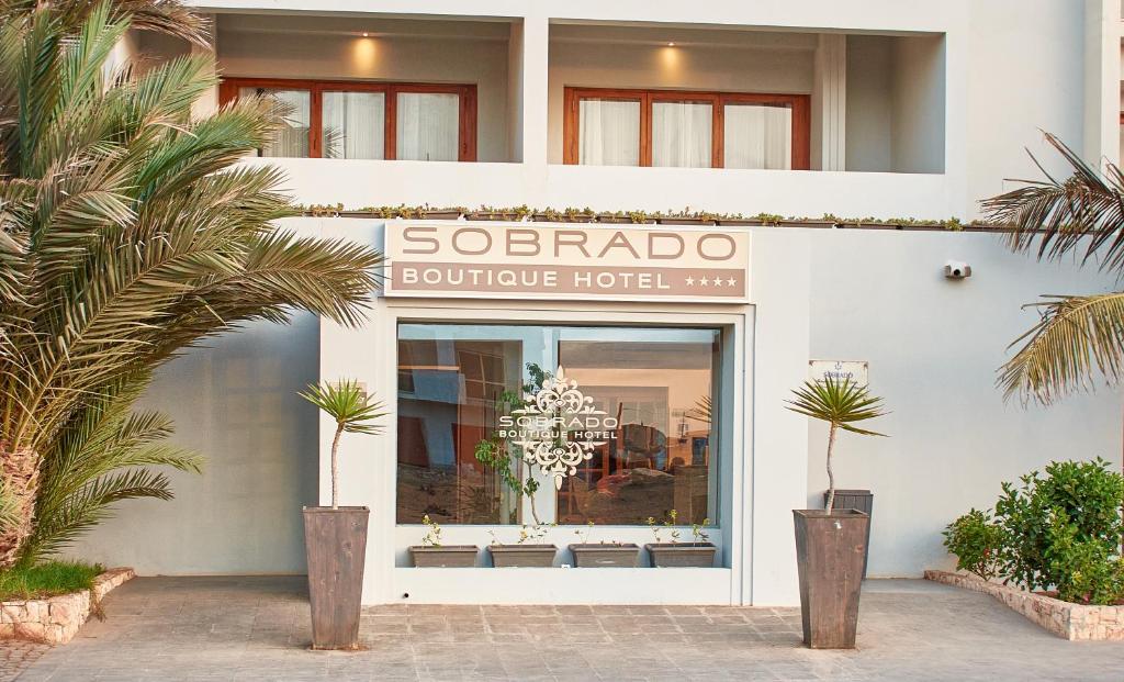 un negozio di fronte con un cartello per un hotel boutique di Sobrado Boutique Hotel a Santa Maria