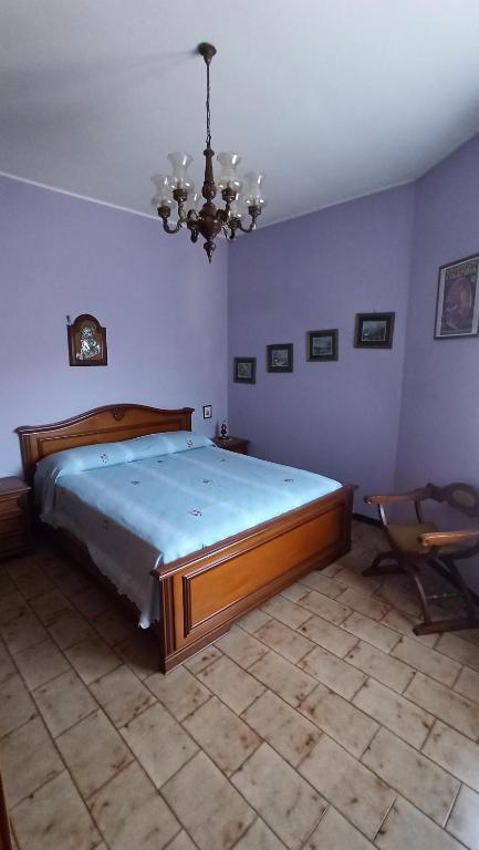 博爾塞納的住宿－Casa Milvia，一间卧室配有一张大床和一个吊灯。