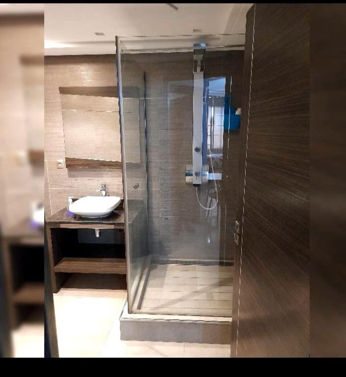 a bathroom with a shower and a sink at Urbain place masira in Casablanca