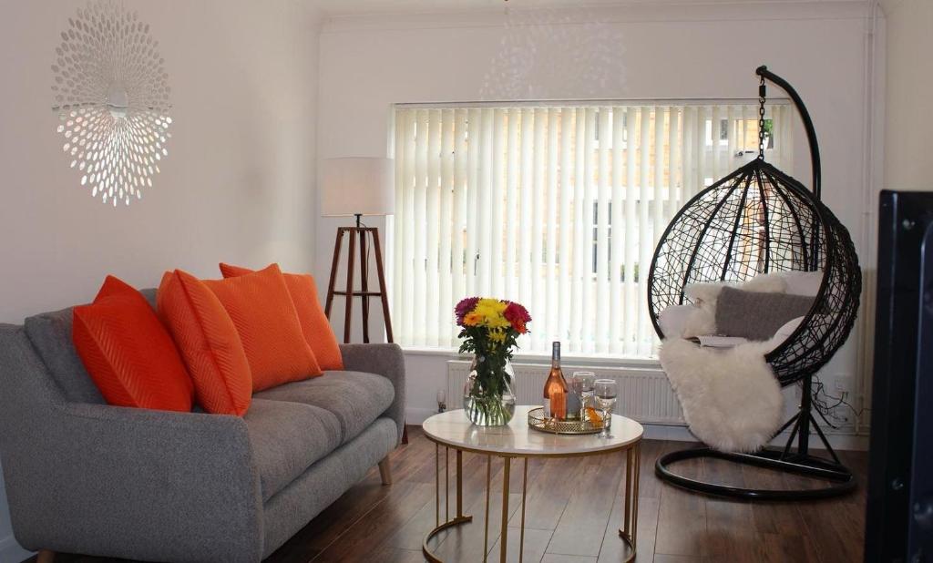 a living room with a couch and a swing at Ely Elegance in Ely