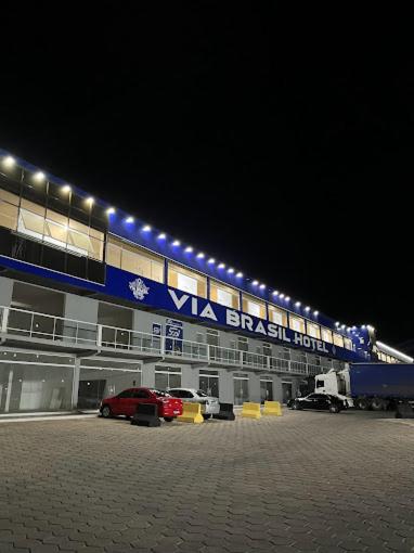 a parking lot in front of a building with lights at Via Brasil Hotel in São Luís