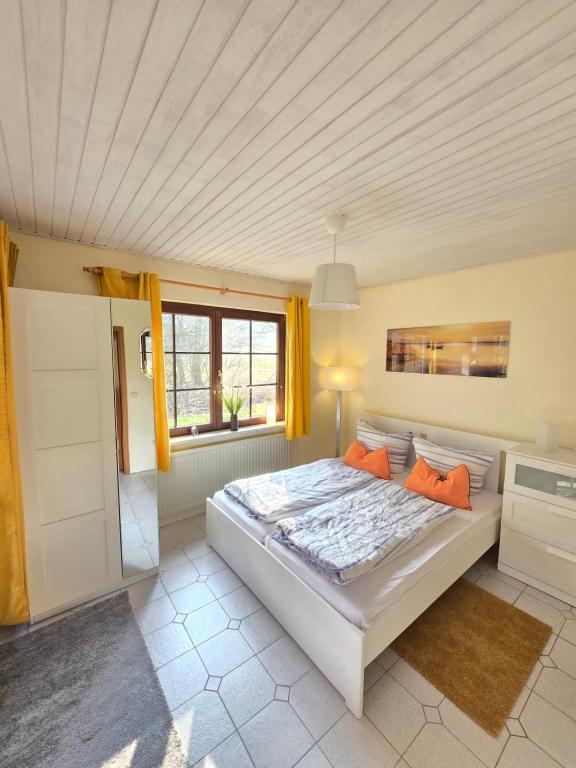 sypialnia z dużym łóżkiem i oknem w obiekcie Haus Seezeit w mieście Plau am See