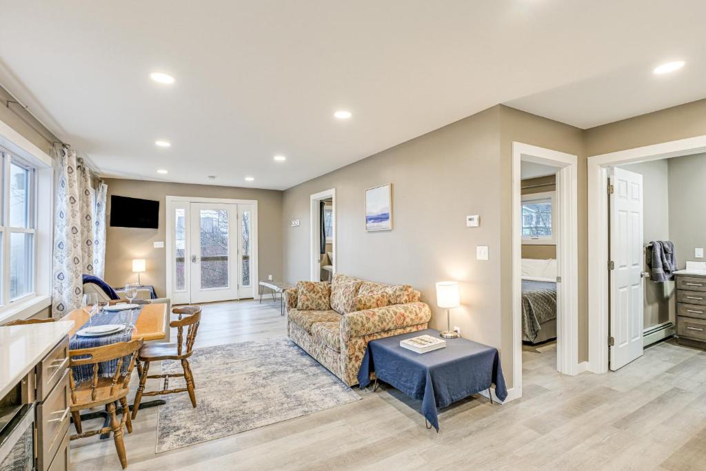 een woonkamer met een bank en een tafel bij Newly Renovated Maine Retreat Deck with Ocean View! in Lubec