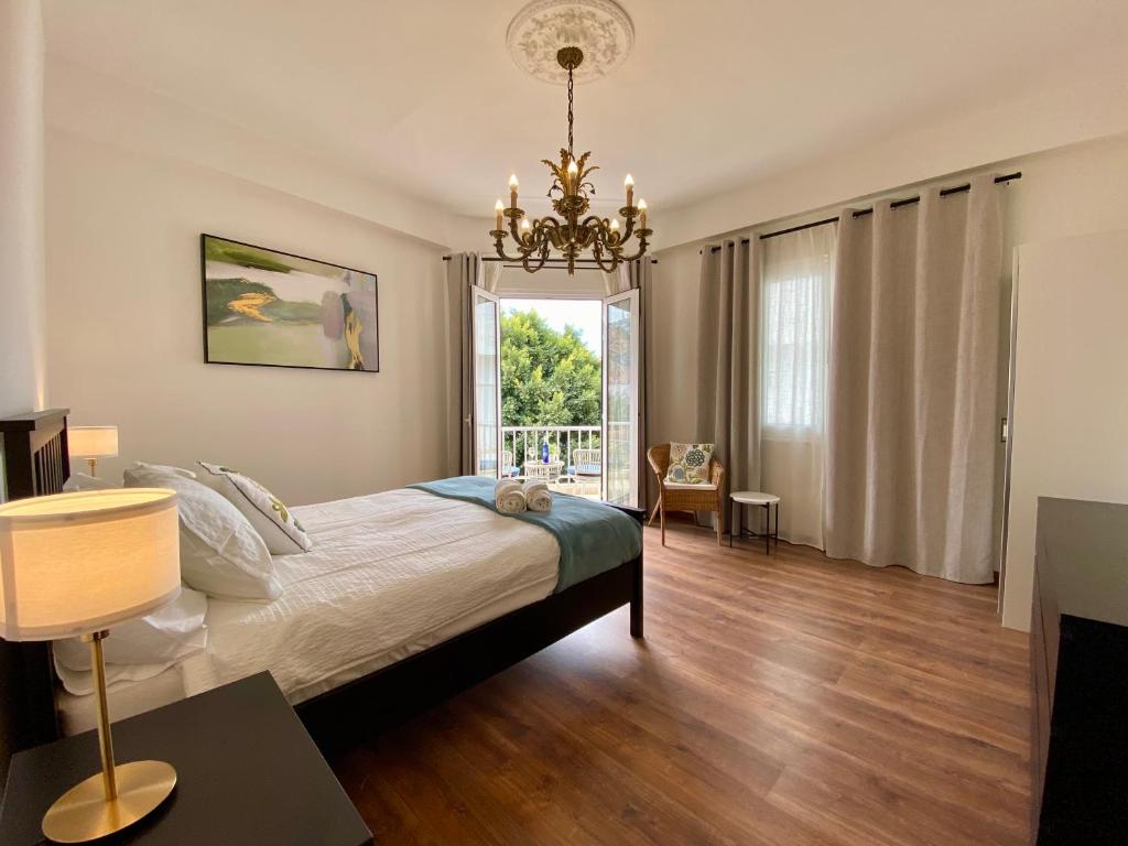 a bedroom with a large bed and a chandelier at VISTA PLAZA - Exceptional Location in Los Llanos de Aridane