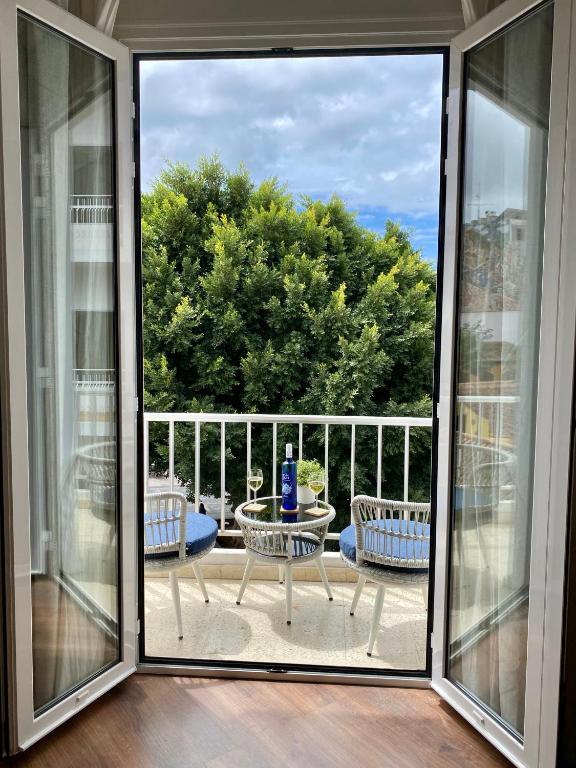 a balcony with a view of a table and chairs at VISTA PLAZA - Exceptional Location in Los Llanos de Aridane