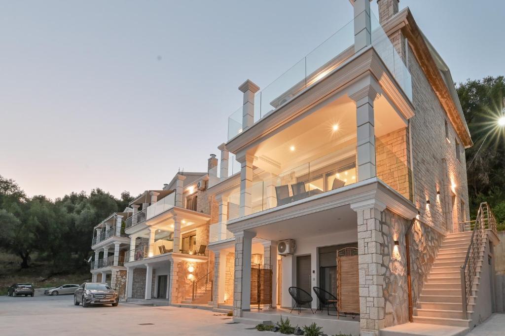 a house with a car parked in front of it at Milion Living Residences in Parga