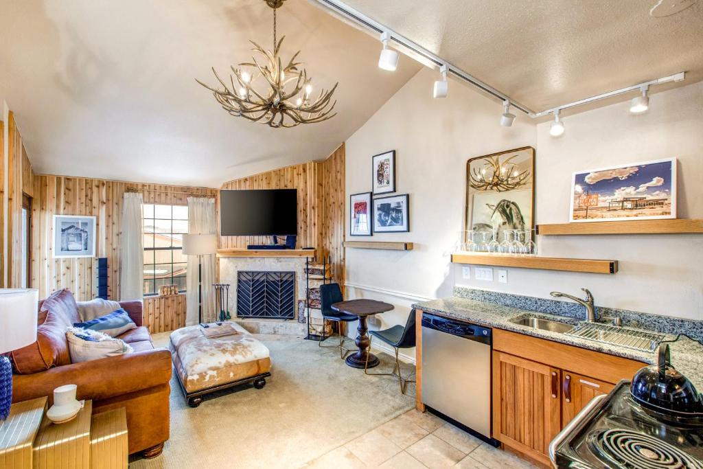 a kitchen and living room with a couch and a fireplace at Copperbottom Inn #310 in Park City