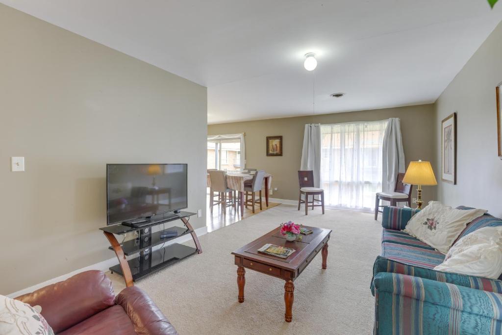 a living room with a couch and a tv at Garden District Home Near Downtown Montgomery in Montgomery