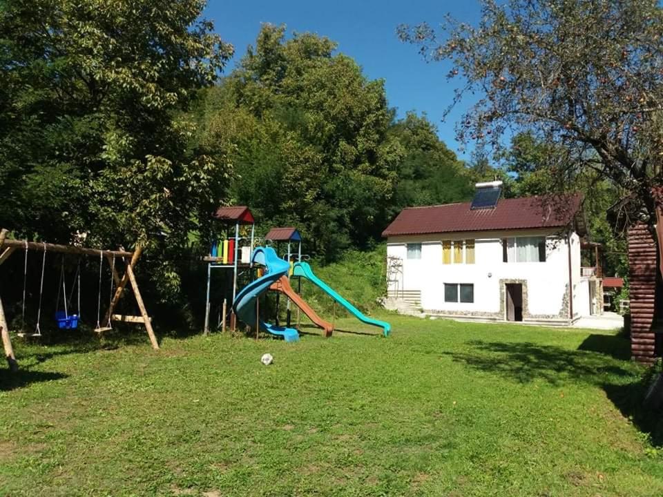 un parque infantil en un patio con tobogán en La Mylii, en Berevoeşti