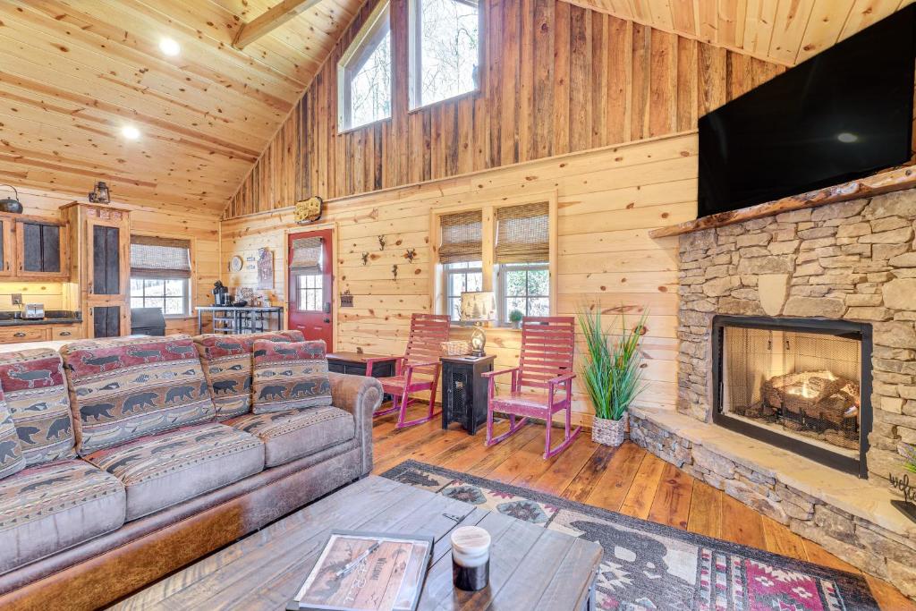 a living room with a couch and a fireplace at Dog-Friendly Cabin with Fire Pit and Hot Tub! in Murphy